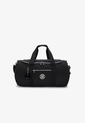 Sac de sport noir en nylon avec double poignée, une sangle d'épaule détachable et une poche zippée à l'avant. Présente un logo et un porte-clés en fourrure.