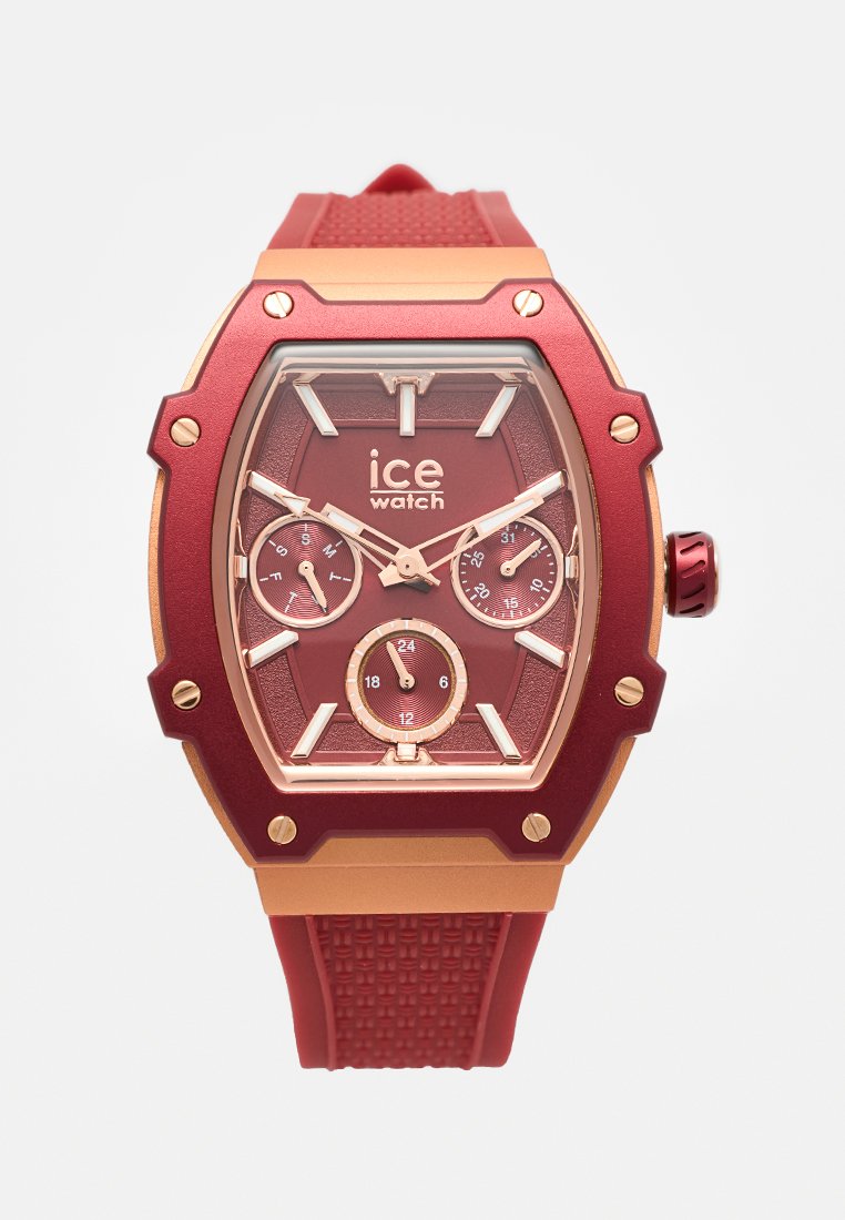 Rote Silikonarmbanduhr mit einem sechseckigen Gehäuse in Rot und Gold, drei Teilzifferblättern, weißen Stundenmarkierungen und einer geprägt strukturierten Band.