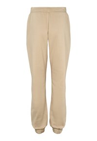 Beige sweatpants i mjukt tyg med elastisk midja, två sidfickor och avsmalnande muddar vid anklarna.