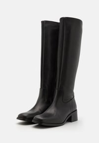 Knee-high black leather boots with a square toe, block heel, side zipper, and smooth texture. Simple, streamlined design with no patterns.