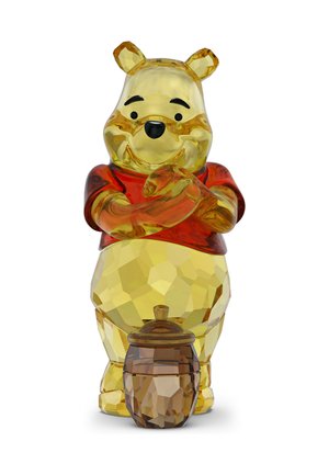Gelbe Kristallfigur von Winnie Puuh im roten Hemd, lächelnd und Händchen haltend, mit einem facettierten Honigtopf zu seinen Füßen.