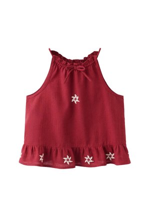 Haut rouge sans manches avec encolure et ourlet à volants, décoré de petits motifs d’étoiles blanches brodées.