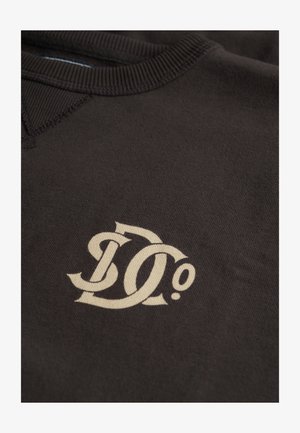 Brown sweatshirt featuring a prominent beige "D0" logo, ribbed neckline, and smooth fabric texture.