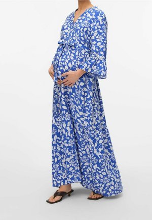 Un vestido maxi azul con estampado floral presenta patrones de hojas blancas, escote en V, mangas acampanadas, cintura imperio y falda de varios niveles.