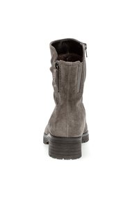 Gray suede ankle boots with a textured finish, featuring a side zipper and a chunky rubber heel for added height and stability.
