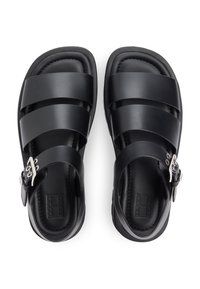 Μαύρα σανδάλια με φαρδιές επίπεδες λουρίδες, κούμπωμα με αγκράφα, μαξιλαρωτό πέλμα και υφή στη σόλα. Κατασκευασμένα από συνθετικό υλικό.