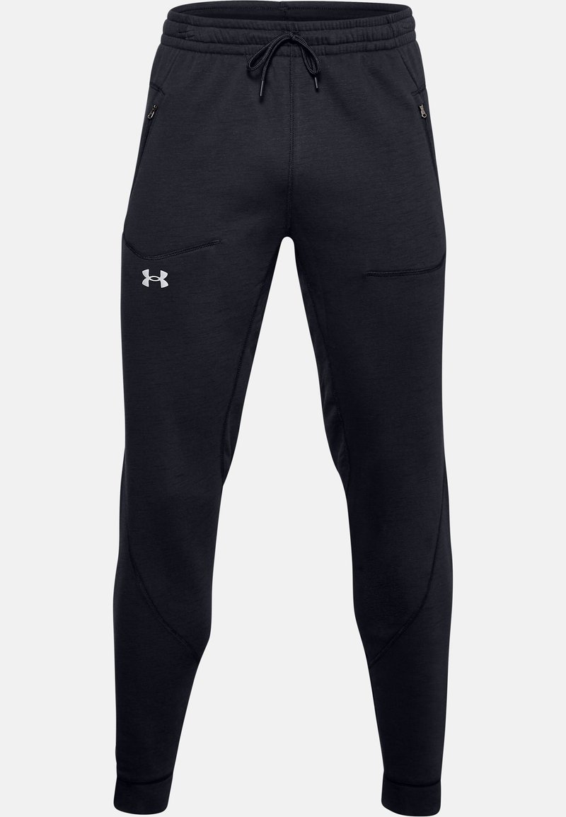 Svarta träningsoveraller av mjukt tyg, med dragsko i midjan, fickor med dragkedja och smalnade ben med elastiska fållar.