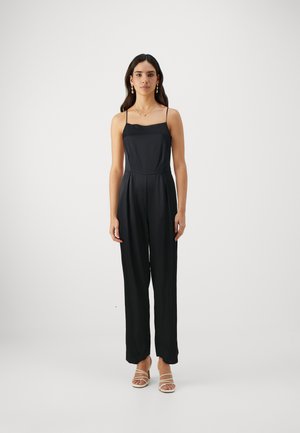 Black jumpsuit with thin straps, a fitted bodice, and wide-leg trousers. Smooth, lightweight fabric with minimal seams and no patterns.