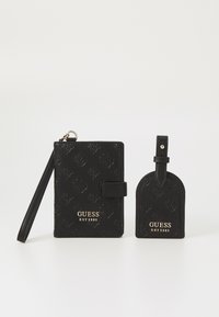 Black wallet and luggage tag set made of textured leather, featuring embossed floral patterns and gold logo detailing.