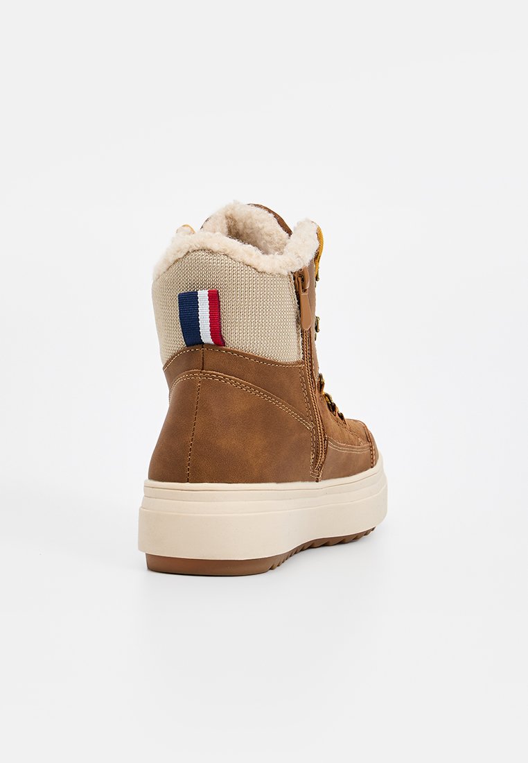 Brauner Lederstiefel mit einem strukturierten beigefarbenen Stoffeinsatz, Kunstfellfutter und einem dreifarbigen Streifendesign. Verfügt über eine dicke weiße Sohle.