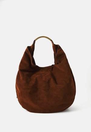 Brown suede hobo bag with a slouchy design and a curved gold-tone metal handle, featuring a smooth texture and minimal stitching details.
