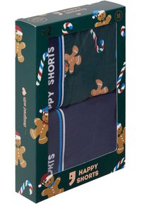 Förpackning med två par herrshorts: ett par mörkgröna med pepparkakemönster, och ett par marinblå med ett midjeband i blå accenter.