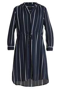 Mörkblå klänning med vita vertikala ränder, långa ärmar, djup V-ringning, elastisk midja med dragsko och en håll-längd nedanför knäet.