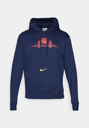 Tums zilas kapuce, kas rotāta ar grafiku ar basketbola bumbu un tiltu sarkanā krāsā, ar priekšējo kangauru kabatu un dzelteno Nike logotipu uz apakšmalas.