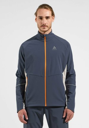 Navy athletic jacket with orange zipper and accents, featuring a high collar, long sleeves, and a smooth, lightweight fabric.