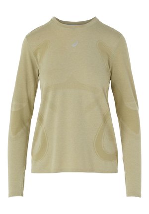 Chemise à manches longues beige clair en tissu athlétique texturé, avec des accents en mesh et un logo sur la poitrine. Coupe ajustée et encolure arrondie.