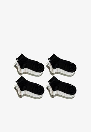Black and white ankle socks, cotton blend, ribbed cuffs, featuring a solid black base and white stripes with gray accents. Four pairs displayed.