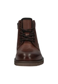 Brown leather ankle boots with round toe, textured panel at the collar, dark laces, and a treaded rubber sole. Logo embossed on the tongue.