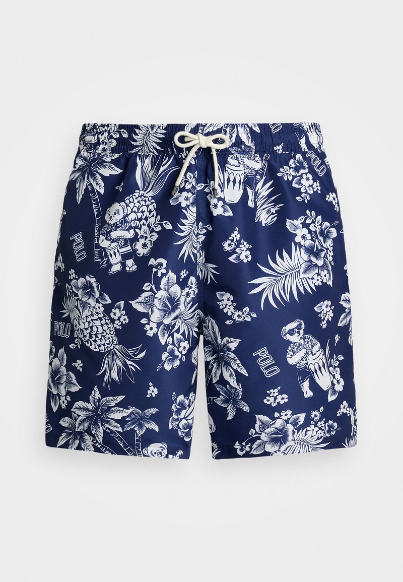 Marinblå simshorts med vitt blommigt och tropiskt tryck med illustrationer och ordet "POLO". Tillverkade av lättviktsmaterial och med elastisk midja.