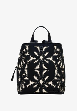 Schwarze Stoffhandtasche mit cremefarbenen, floralem Durchbruchmuster, strukturierte Oberfläche, zwei Henkel und Reißverschluss. Logo an der Basis.