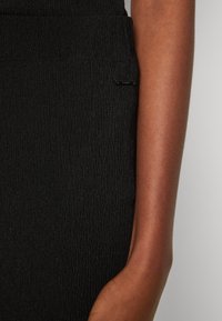 Calvin Klein CRINKLED FLARED - Pantaloni - black