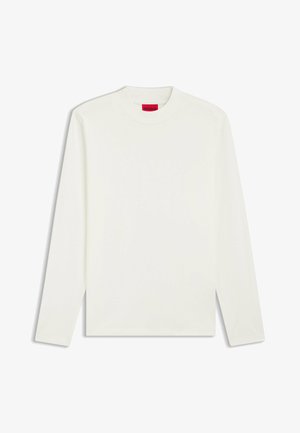 Long-sleeve, crew-neck shirt in off-white fabric with smooth texture. Features a red "HUGO" label on the neck. Simple, unadorned design.