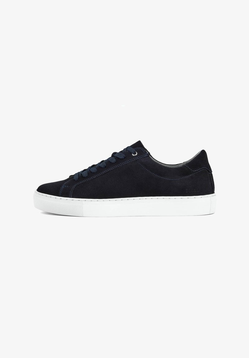 Navy suede sneaker with white rubber sole, round toe, and contrasting blue stitching. Features flat laces and subtle branding on the side.