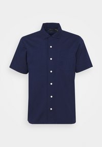 Kortärmad, marinblå skjorta med knappar tillverkad i bomull, med krage, en bröstficka och vita knappar.