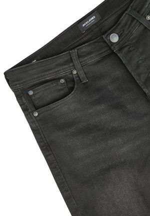 Black denim jeans featuring a classic cut, front pocket, metal hardware, and subtle fading on the fabric for texture. Brand label visible.