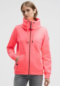 Bright pink hoodie featuring a high collar, front zipper, drawstring, and two front pockets. Made from soft, textured fabric.