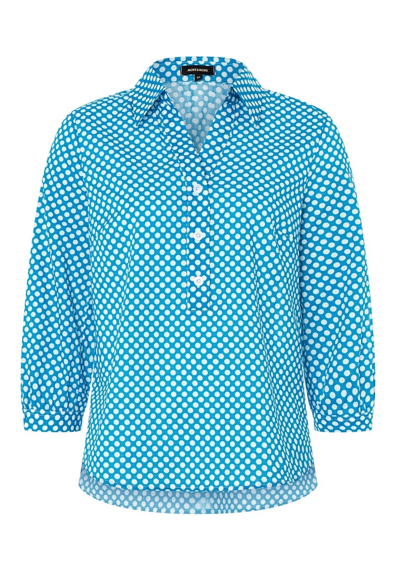 Chemise bleu à boutons avec des pois blancs, dotée d'un col, de manches trois-quarts et d'une poche avant. Fabriquée en tissu léger.