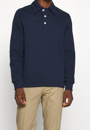 Marineblaue Langarm-Polohemden aus weichem Material, mit klassischem Kragen, Knopfleiste mit drei Knöpfen und gerippten Bündchen.