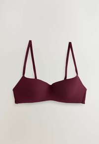 Burgundin värinen ribatettu rintaliivi, jossa on ohuet säädettävät hihnat ja pitsikoristeet sivuilla. Sujuva pinta ja muotoillut kupit tukevat.