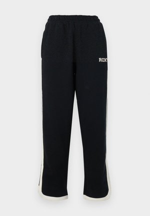 Pantaloni sportivi neri con vita elastica, strisce laterali bianche e un piccolo logo sul davanti. Realizzati in un morbido tessuto testurizzato.