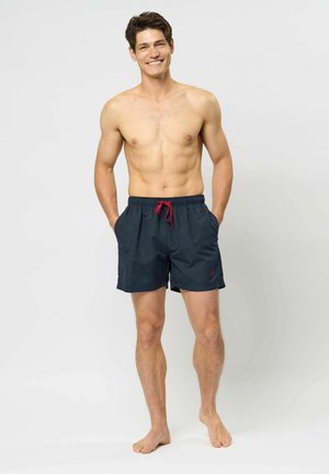 Marineblaue Badeshorts mit rotem Kordelzug, elastischem Bund und Seitentaschen. Hergestellt aus leichtem Stoff, entworfen für Komfort und Bewegungsfreiheit.