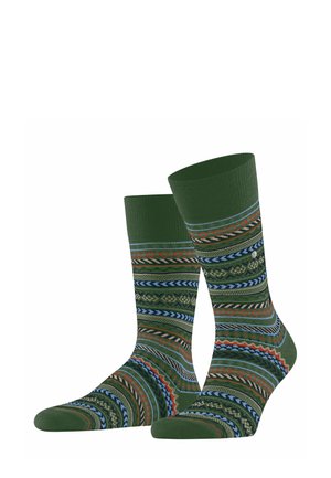 Chaussettes vertes à motifs avec divers designs géométriques en bleu, rouge et orange, dotées d'une bande côtelée pour l'élasticité et le confort.