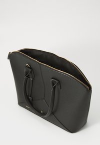 Black tote bag made of textured synthetic material. Features a zippered closure, two handles, and gold-tone hardware. Spacious interior.