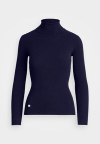 Marinblå ribbad turtleneck-tröja med långa ärmar, åtsittande design och liten logotyp-patch vid fållen. Tillverkad av ett elastiskt, strukturerat material.