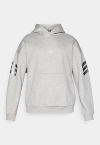 Sweatshirt cinza com capuz e bolso frontal, apresentando um pequeno logo refletor e três riscas pretas em cada manga. Feito de um tecido macio e texturado.