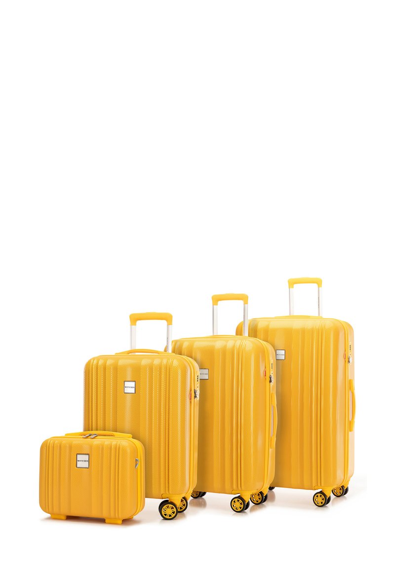 Geel harde koffer set met een ribbelontwerp, bestaande uit vier stukken in verschillende maten, uitgerust met telescoopgrepen en dubbele wielen.