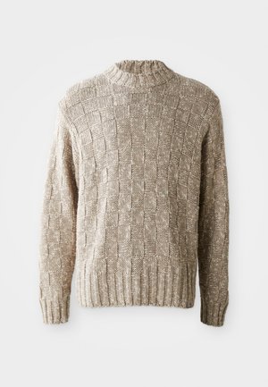 Maglione lavorato a maglia beige con un motivo a scacchiera testurizzato, scollo e orlo a coste, e maniche lunghe. Realizzato in un materiale morbido e leggero.