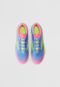 Lightweight athletic shoes in blue, pink, and neon green. Smooth texture, lace-up design, and angular stripes on the upper. Breathable material.