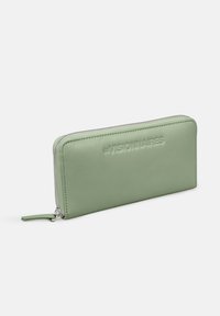 Green leather wallet with a smooth texture, zip closure, and embossed brand name, rectangular shape with a sleek design.