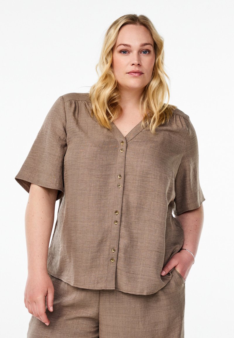 Brown, short-sleeved blouse with a V-neck and button front. Made from a textured fabric, featuring a relaxed fit and a slightly curved hem.