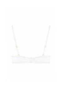 Soutien-gorge blanc avec bretelles réglables, design sans couture et accents en métal doré. Il présente un style confortable et minimaliste, idéal pour le superposition.