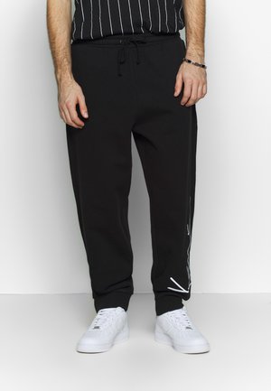 SIGNATURE RETRO - Tracksuit bottoms - black/white