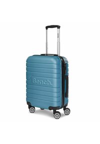 Hartschalen-Teal-Reisetasche mit auffälligem geripptem Design, schwarzem Akzentgriff und Rädern sowie einem Reißverschlussverschluss. Enthält das Markenlogo.