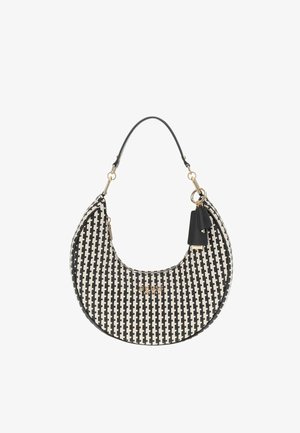 Sac rond en noir et blanc avec un motif tissé. Équipé de quincaillerie dorée et d'une bandoulière en cuir noir avec un pompon décoratif.