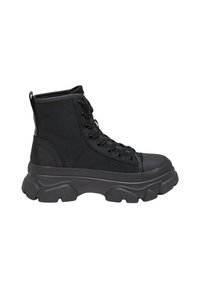 Black lace-up ankle boots featuring a textured fabric upper, rubber toe cap, and chunky rubber sole with pronounced tread pattern.