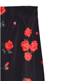Black fabric featuring a floral design in vibrant red roses with green leaves, showcasing a smooth texture and satin-like finish.